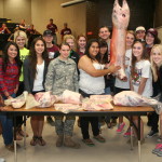 Animal Science students with lamb carcass and cuts