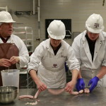 Wes Osburn, Crystal Waters, and Michael Yeater linking bratwurst