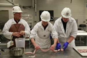 Wes Osburn, Crystal Waters, and Michael Yeater linking bratwurst